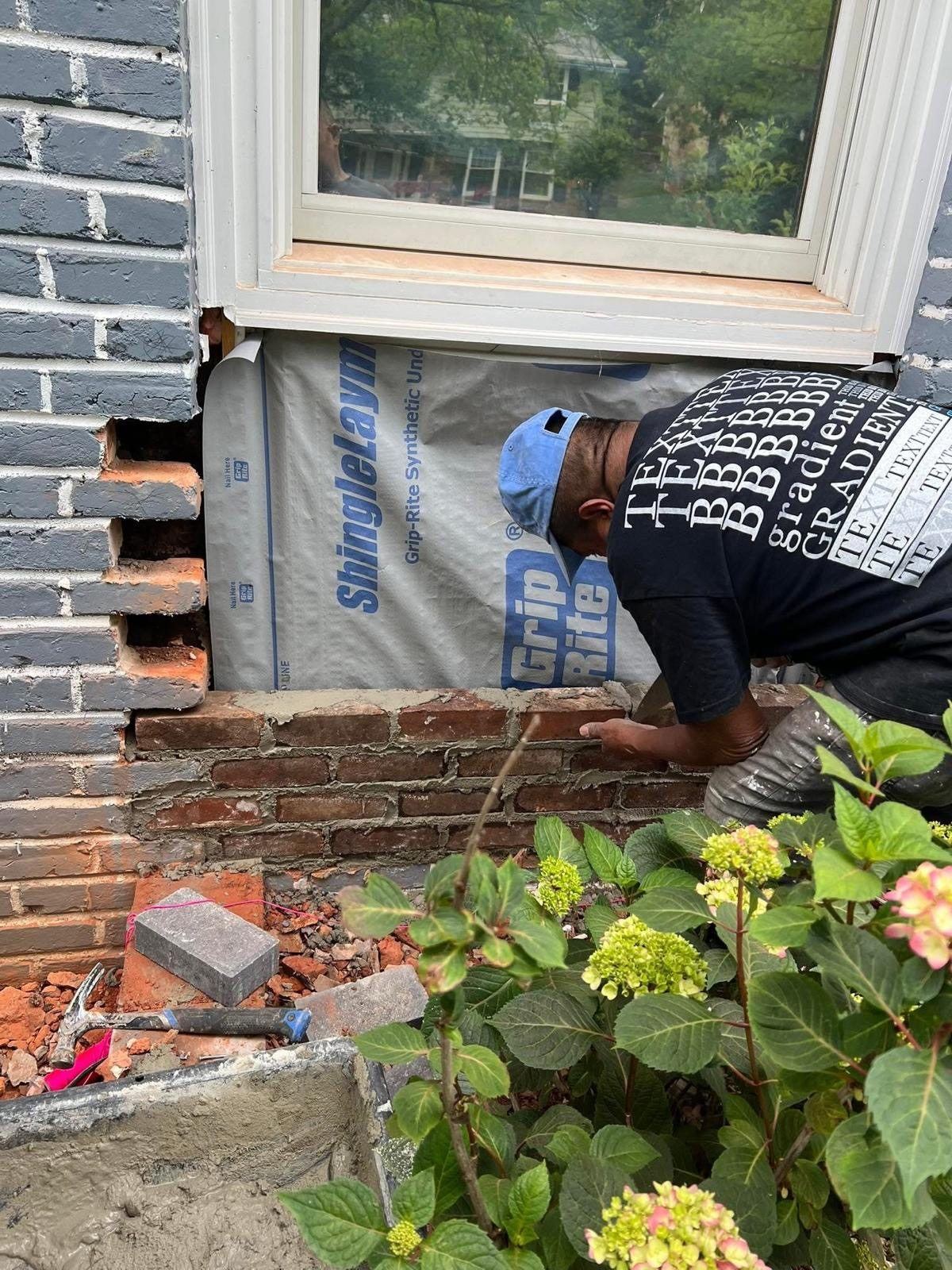 Brick and masonry repair below a window