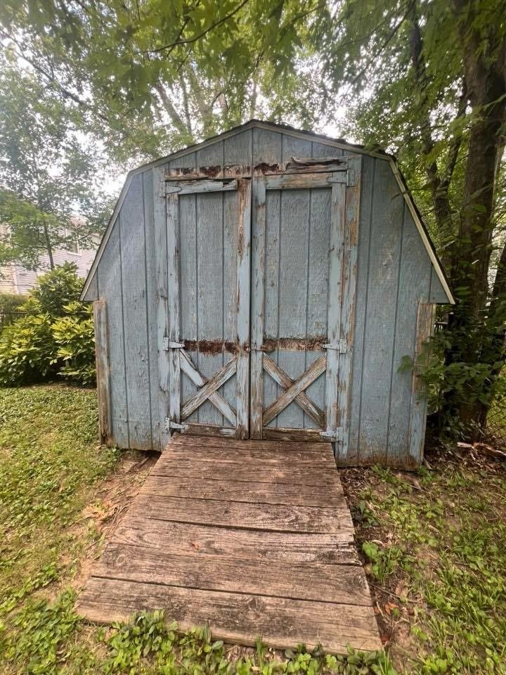 Weathered shed doors before repair
